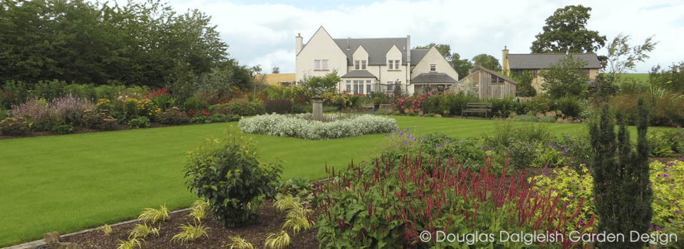 view across large garden site during construction, with landscaper at work